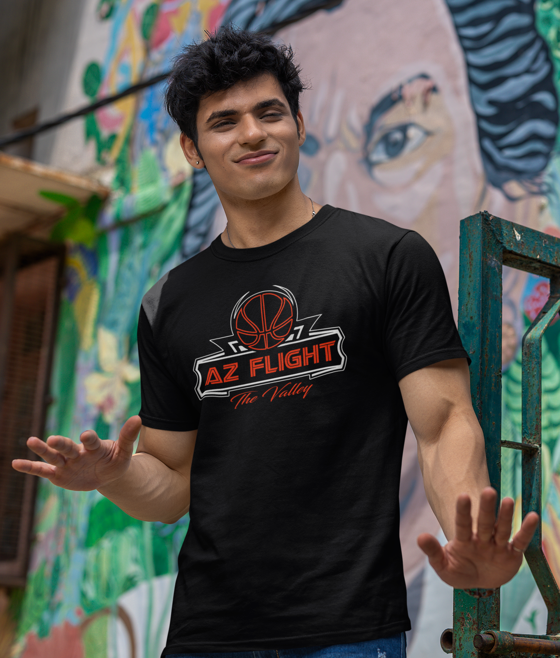 Player showing off AZ Flight tee in front of mural